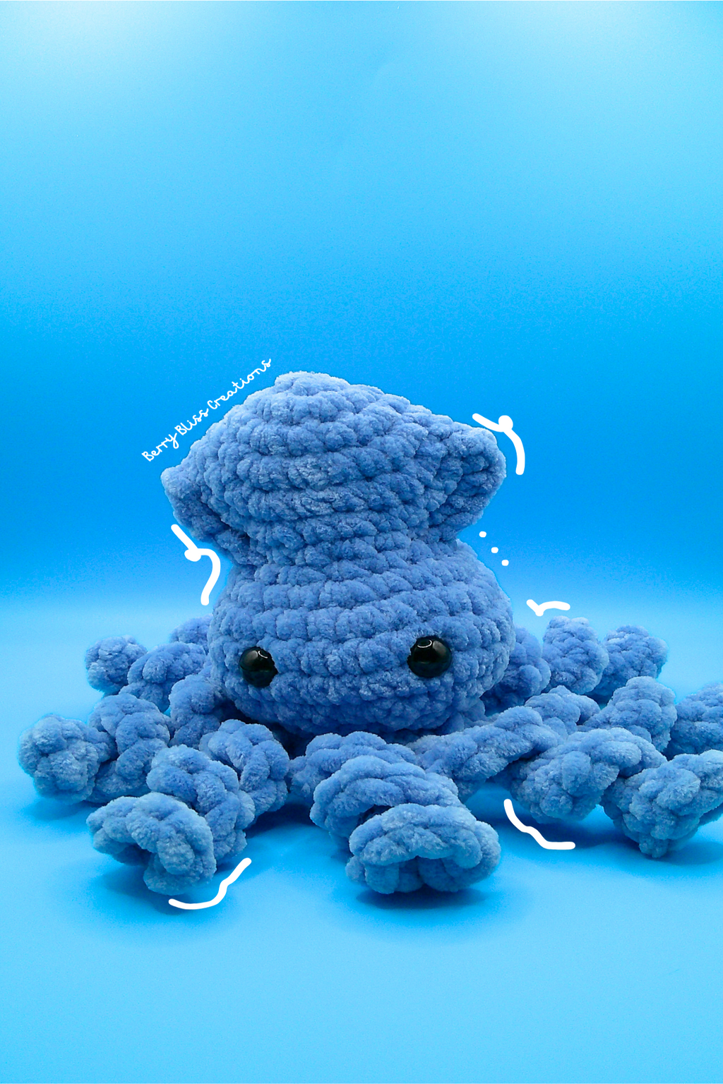 A crocheted octopus plush toy in light blue yarn, featuring small black bead eyes.
