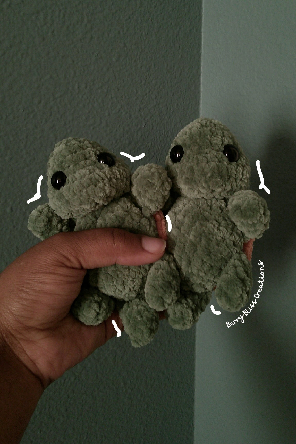 A small plush toy turtles. The turtles are olive green with black bead eyes and brown shell on their backs.