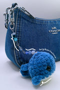 A  blue crocheted whale charm and beaded keychain attached, (Coach shoulder bag not included)