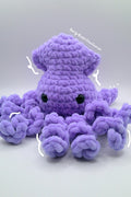 A purple crocheted octopus plush toy with black bead eyes.